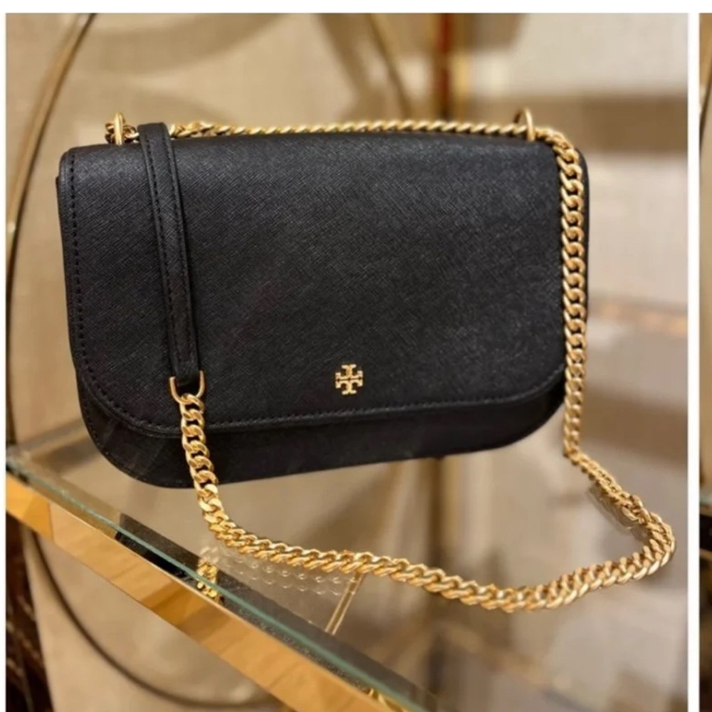 Tory burch cross body bag with a l finish touch of gold and a golden strap